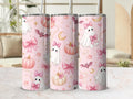 Preview of white ghosts with pink bows, pumpkins, bats, candy corn, moons and pearl-like details on a tumbler mockup