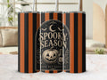 Preview of orange and black stripes, a crescent moon, bats, a jack-o-lantern, a potion bottle and Spooky Season lettering on a tumbler mockup